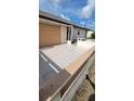 Large tiled patio perfect for entertaining, with a retractable sun shade, ideal for relaxation and outdoor dining at 13366 Ballon Ave, Port Charlotte, FL 33981