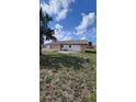 Expansive backyard featuring a patio and green space, ideal for outdoor gatherings and relaxation at 13366 Ballon Ave, Port Charlotte, FL 33981