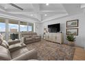 Cozy living room with recessed lighting, an entertainment center, and access to an outdoor balcony at 1425 Park Beach Cir # 1310, Punta Gorda, FL 33950