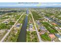Aerial view of waterfront community with direct access to open water for boating at 15104 Aldama Cir, Port Charlotte, FL 33981