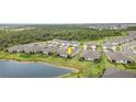 An aerial view showcases the home's position near a pond and lush green spaces in a beautiful neighborhood at 16965 Hawk Ct, Punta Gorda, FL 33982