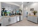 Kitchen with granite counters and stainless appliances, overlooking the dining and living areas at 17857 Woodland Ct, Punta Gorda, FL 33982