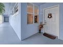 Building entryway with a white door and an arrangement on the floor at 2001 Bal Harbor Blvd # 2306, Punta Gorda, FL 33950