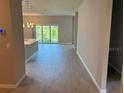 Open-concept living space with sliding glass doors and neutral walls at 207 Baytree Dr, Rotonda West, FL 33947