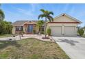 Inviting single Gathering home with a well-maintained lawn, mature landscaping, and a 2-car garage at 219 Tait Se Ter, Port Charlotte, FL 33952