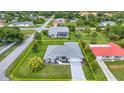 An aerial view of the property showcasing the home's layout, surrounding landscape, and neighborhood at 229 Waterside St, Port Charlotte, FL 33954