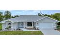 Charming single Gathering home boasting a beautifully landscaped front yard and a pristine white exterior at 229 Waterside St, Port Charlotte, FL 33954