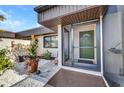 Charming entrance featuring an inviting doorway, decorative planters, and a peaceful sitting area at 232 W Henry St, Punta Gorda, FL 33950