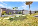 Front exterior view of a home featuring a decorative fence, lush landscaping, and a well-manicured lawn at 232 W Henry St, Punta Gorda, FL 33950