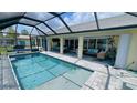Inviting pool area with screened enclosure and ample seating for relaxation and entertainment at 2399 Bendway Dr, Port Charlotte, FL 33948