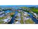 Canal-front home with private boat dock access to the bay, situated among lush landscaping and waterfront properties at 24239 Yacht Club Blvd, Punta Gorda, FL 33955