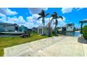 Waterfront home with direct canal access, a private boat ramp and parking, and a storage shed among palm trees at 24239 Yacht Club Blvd, Punta Gorda, FL 33955