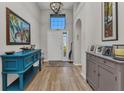 Welcoming foyer with a high ceiling, decorative console table, and attractive hardwood flooring at 24358 Folkstone Ave, Punta Gorda, FL 33980