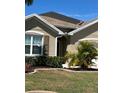 A close-up of the exterior of the home, highlighting a window and landscaping at 25008 Lalique Pl, Punta Gorda, FL 33950