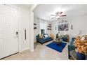 Bright living room featuring tile floors, stylish furniture, and decorative shelving at 2515 Sherman Oak Dr, North Port, FL 34289