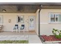 Charming front porch with seating area, perfect for relaxing and enjoying the neighborhood ambiance at 25275 Rampart Blvd # 1504, Punta Gorda, FL 33983