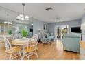 Bright and airy living room featuring stylish furniture, hardwood floors, and sliding glass doors to outdoor space at 25275 Rampart Blvd # 1504, Punta Gorda, FL 33983