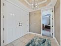 Elegant foyer features a chandelier and double doors leading to a bedroom, offering a stylish entry at 2590 N Beach Rd # 5, Englewood, FL 34223