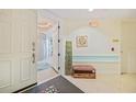 Welcoming hallway with a decorative bench and coastal decor, creating a warm and inviting entrance at 2590 N Beach Rd # 5, Englewood, FL 34223