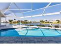 Inviting screened-in pool and spa area with a picturesque water view at 261 Venezia Ct, Punta Gorda, FL 33950