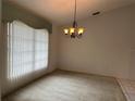 Inviting dining room featuring a chandelier and carpeted floors at 3233 Meadow Run Dr, Venice, FL 34293