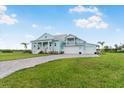 Lovely two-story home with a three-car garage, paver driveway, and well-maintained lawn at 3548 Mondovi Ct, Punta Gorda, FL 33950