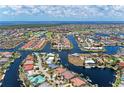 Expansive aerial view showcases the waterfront neighborhood with lush greenery and boat access at 3800 Bal Harbor Blvd # 414, Punta Gorda, FL 33950