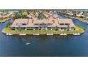 Scenic waterfront view of townhouse with private dock and a person kayaking nearby at 3800 Bal Harbor Blvd # 414, Punta Gorda, FL 33950
