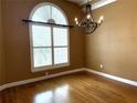 Inviting dining room with hardwood floors, large window with blinds, and elegant chandelier at 4150 Enclave Pl, Punta Gorda, FL 33980
