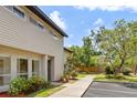 Charming two-story townhome with a well-manicured lawn, walkway, and beautiful landscaping at 4346 Rayfield Dr # 4346, Sarasota, FL 34243