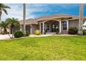 Inviting residence showcasing a well-kept lawn and meticulous landscaping, creating a warm and welcoming atmosphere at 523 Saint Girons Ct, Punta Gorda, FL 33950