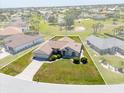 An aerial view of a single Gathering home in a neighborhood with green lawn at 7334 N Tulip Tree, Punta Gorda, FL 33955