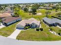 An aerial view of a single Gathering home in a neighborhood with green lawn at 7334 N Tulip Tree, Punta Gorda, FL 33955
