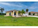 A charming single-story home featuring a lush green lawn, desert landscaping, and a spacious driveway leading to a two-car garage at 7512 Pon Kan, Punta Gorda, FL 33955