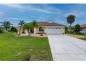 Well-maintained one-story home, featuring a lush front lawn, rock landscaping, and a two-car garage at 7512 Pon Kan, Punta Gorda, FL 33955