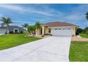 Charming one-story home with a two-car garage, complemented by palm trees and a green lawn at 7512 Pon Kan, Punta Gorda, FL 33955