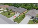 An aerial view of the home's roof, driveway and landscaping at 7652 Mikasa Dr, Punta Gorda, FL 33950