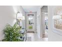 Bright entryway with stylish decor, a glass console table, and a clear view to the front door at 9710 Sand Dune Ln, Punta Gorda, FL 33950
