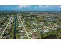 Aerial view showcasing a well-planned community with canals, lakes and nearby ocean access at 1 Sportsman Cir, Rotonda West, FL 33947