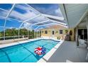 Inviting screened-in pool area with a vibrant pool, spacious deck, and sunny atmosphere at 1 Sportsman Cir, Rotonda West, FL 33947