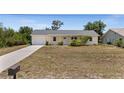 Charming single-story home with a well-maintained lawn and a cozy, inviting facade at 10133 Gulfstream Blvd, Englewood, FL 34224