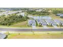 Aerial view of modern homes near a pond and lush greenery in a well-planned community at 11088 Pinot Dr, Venice, FL 34293