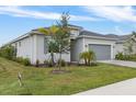 A single-story home displays a manicured lawn, stone driveway, and well-maintained landscaping at 11088 Pinot Dr, Venice, FL 34293