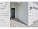 A beautifully decorated front door welcomes you to this home, complemented by stylish exterior lighting at 15069 Anchorage Rd, Punta Gorda, FL 33982