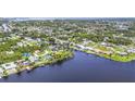 Scenic aerial shot of waterfront homes with private docks along a tranquil waterway surrounded by greenery at 18585 Klingler Cir, Port Charlotte, FL 33948