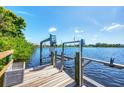 Waterfront dock with boat lift on a sunny day, offering direct access to the open water at 18585 Klingler Cir, Port Charlotte, FL 33948