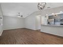Open-concept living room featuring hardwood floors, modern lighting, and view of the kitchen at 2101 W Cherry St, Tampa, FL 33607