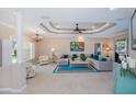 Elegant living room with tray ceilings, a chandelier, and comfortable seating arrangement at 2387 Nuremberg Blvd, Punta Gorda, FL 33983