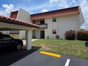 Exterior of condo with carport and landscaped front yard at 311 Garvin St # 405B, Punta Gorda, FL 33950