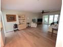 Spacious living room with wood flooring, ceiling fan, and sliding glass doors at 311 Garvin St # 405B, Punta Gorda, FL 33950